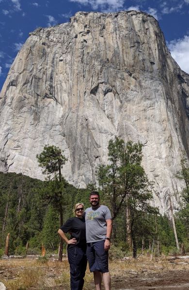 Morgan and her husband standing in front of a mountain